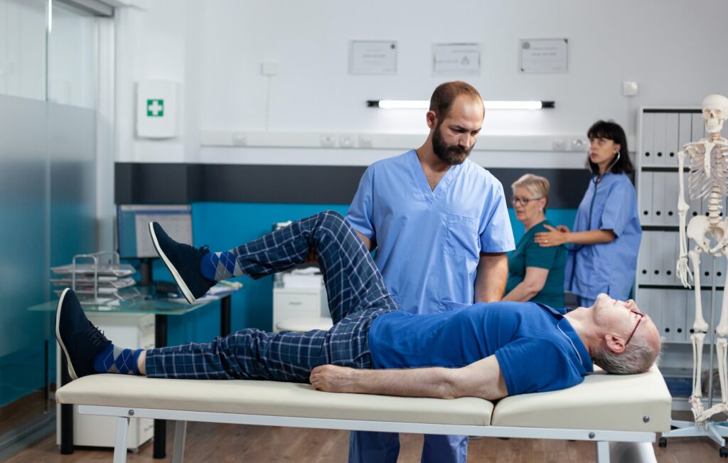 Man with leg muscle injury receiving orthopedic massage